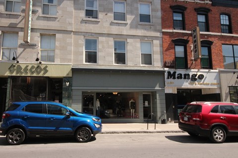 a couple of cars parked in front of a building